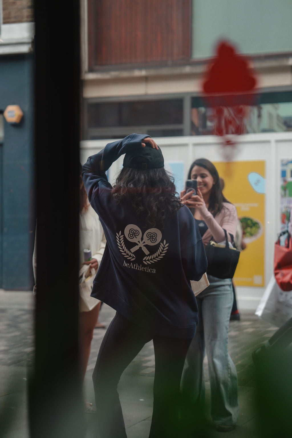 Girl Taking Photo in Navy Zip-Up Sweatshirt