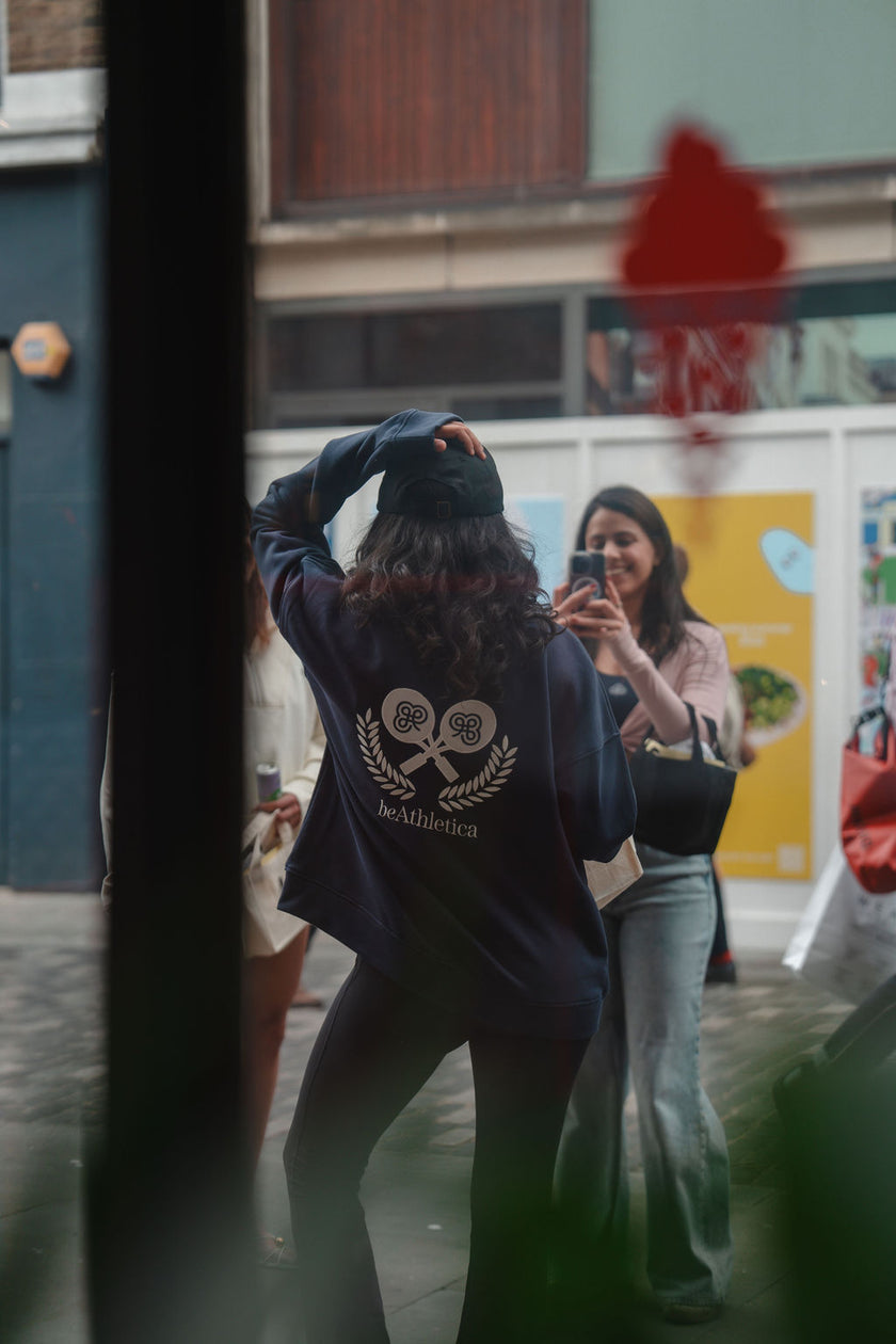 Girl Taking Photo in Navy Zip-Up Sweatshirt