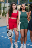 Be 180 Cycling Shorts - Forest and Cherry | Girls Wearing Green and Red Shorts on Padel Court 